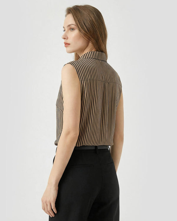 Woman wearing a sleeveless striped blouse and black pants on a white background- sfosh