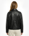 Black leather jacket worn by a person on a white backgroundBlack leather jacket on a white background - sfosh