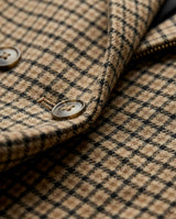 Close-up of checkered fabric with a button, showing texture and pattern details. - sfosh