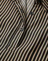 Close-up of a black and beige striped shirt with buttons.- sfosh