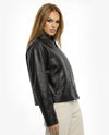 Woman wearing a black leather jacket on a white backgroundBlack leather jacket on a white background - sfosh