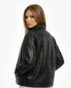 Woman wearing a black leather jacket on a white backgroundBlack leather jacket on a white background - sfosh