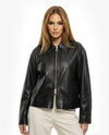 Woman wearing a black leather jacket on a white backgroundBlack leather jacket on a white background - sfosh